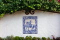Pretty traditional antique tile wall ornament representing a soldier mounted on horse in blue on white