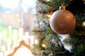 Pretty traditional gold Christmas tree bauble hanging near a win Royalty Free Stock Photo