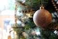 Pretty traditional gold Christmas tree bauble hanging near a win Royalty Free Stock Photo