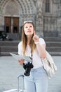 Pretty traveling girl using paper map