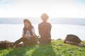 Pretty traveling women on top of mountain at sunset and using mobile phone.