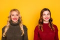 Pretty two chatterbox ladies silly look eyes know new rumours wear knitted jumpers isolated yellow background