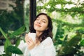 Pretty vietnamese woman enjoying her morning coffee on a veranda Royalty Free Stock Photo