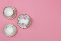 Pretty vintage china teacups on a pale pink background Royalty Free Stock Photo