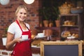Pretty waitress holding two cups of coffees Royalty Free Stock Photo