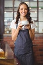 Pretty waitress offering a cup of coffee Royalty Free Stock Photo