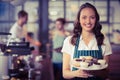 Pretty waitress showing a plate of cupcakes Royalty Free Stock Photo