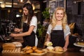 Pretty waitresses behind the counter working Royalty Free Stock Photo