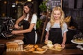 Pretty waitresses behind the counter working Royalty Free Stock Photo