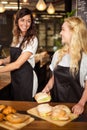 Pretty waitresses behind the counter working Royalty Free Stock Photo