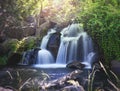 Pretty waterfall with slow shutterspeed for cascading water softening with a vintage retro instagram filter Royalty Free Stock Photo