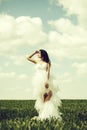 Pretty wedding girl on green grass and sky Royalty Free Stock Photo