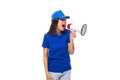 pretty well-groomed young promoter woman in a blue cotton t-shirt and cap uses a loudspeaker to announce promotional