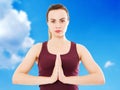 Pretty white woman in namaste pose on blurred sky background, healh care concept,calm girl,namaste gesture,close-up of hands Royalty Free Stock Photo