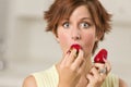 Pretty Wide-eyed Woman Biting Strawberry Royalty Free Stock Photo