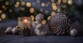 pretty winter time decoration of candle, angel and pine cone, in the background are golden lights