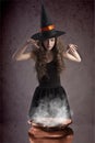 Pretty witch making some spells Royalty Free Stock Photo