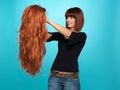 Pretty woman admiring long hair wig Royalty Free Stock Photo