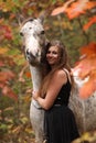 Pretty woman with appaloosa horse in autumn Royalty Free Stock Photo