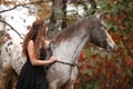 Pretty woman with appaloosa horse in autumn Royalty Free Stock Photo