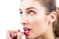 Pretty woman applying lip gloss make up Royalty Free Stock Photo