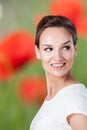 Pretty woman on background with corn poppies