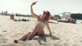 Pretty woman in bikini sitting on the beach and taking a selfie. Royalty Free Stock Photo