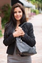 Pretty woman in black jacket and gray dress.