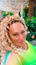 Pretty woman with blonde curly hair and blue eyes in bright clothes Royalty Free Stock Photo