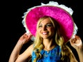 Pretty woman in blue dress holding pink hat