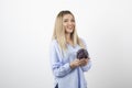 Pretty woman in blue outfit holding single cabbage on white background