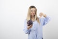 Pretty woman in blue outfit posing with single cabbage on white background