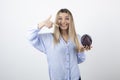 Pretty woman in blue outfit posing with single cabbage on white background