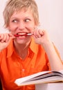 Pretty woman with book biting a pen Royalty Free Stock Photo