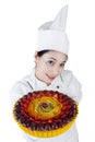 Pretty woman chef holding a cake Royalty Free Stock Photo