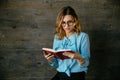 Pretty woman with confused face during reading a book