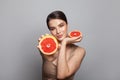 Pretty woman with delicious grapefruit in her arms portrait Royalty Free Stock Photo