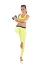 Pretty woman doing wearing sports neon yellow bra and leggings doing exercises for press muscles in a standing position using two Royalty Free Stock Photo