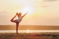 Pretty woman doing yoga at sunset outdoors Royalty Free Stock Photo