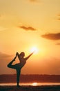 Pretty woman doing yoga at sunset outdoors Royalty Free Stock Photo