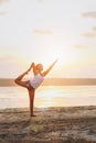 Pretty woman doing yoga at sunset outdoors Royalty Free Stock Photo