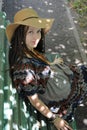 Pretty woman with dreadlocks portrait, dressed in boho style dress and hat Royalty Free Stock Photo