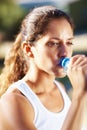 Pretty woman drinking water. Closeup of pretty woman drinking water from bottle after workout. Royalty Free Stock Photo