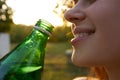 pretty woman drinking water from a green bottle close-up Royalty Free Stock Photo