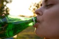 pretty woman drinking water from a green bottle close-up Royalty Free Stock Photo