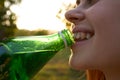 pretty woman drinking water from a green bottle close-up Royalty Free Stock Photo