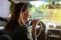 Pretty woman driving using cell phone in car Royalty Free Stock Photo