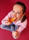 Pretty woman eating pizza and showing thumbs up Royalty Free Stock Photo