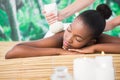 Pretty woman enjoying a herbal compress massage Royalty Free Stock Photo
