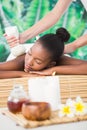 Pretty woman enjoying a herbal compress massage Royalty Free Stock Photo